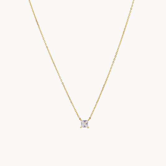 A delicate gold chain necklace with a single solitaire diamond pendant in a four-prong setting