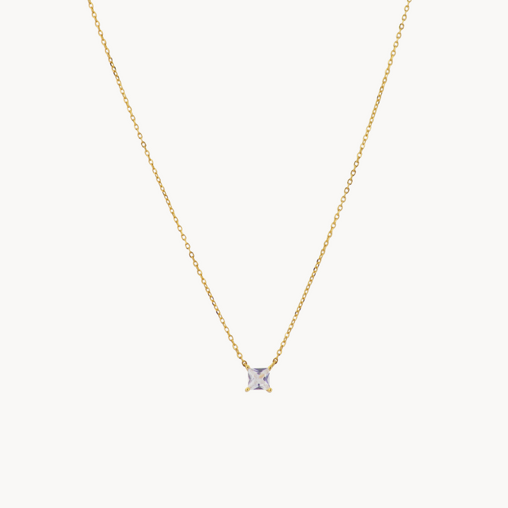 A delicate gold chain necklace with a single solitaire diamond pendant in a four-prong setting