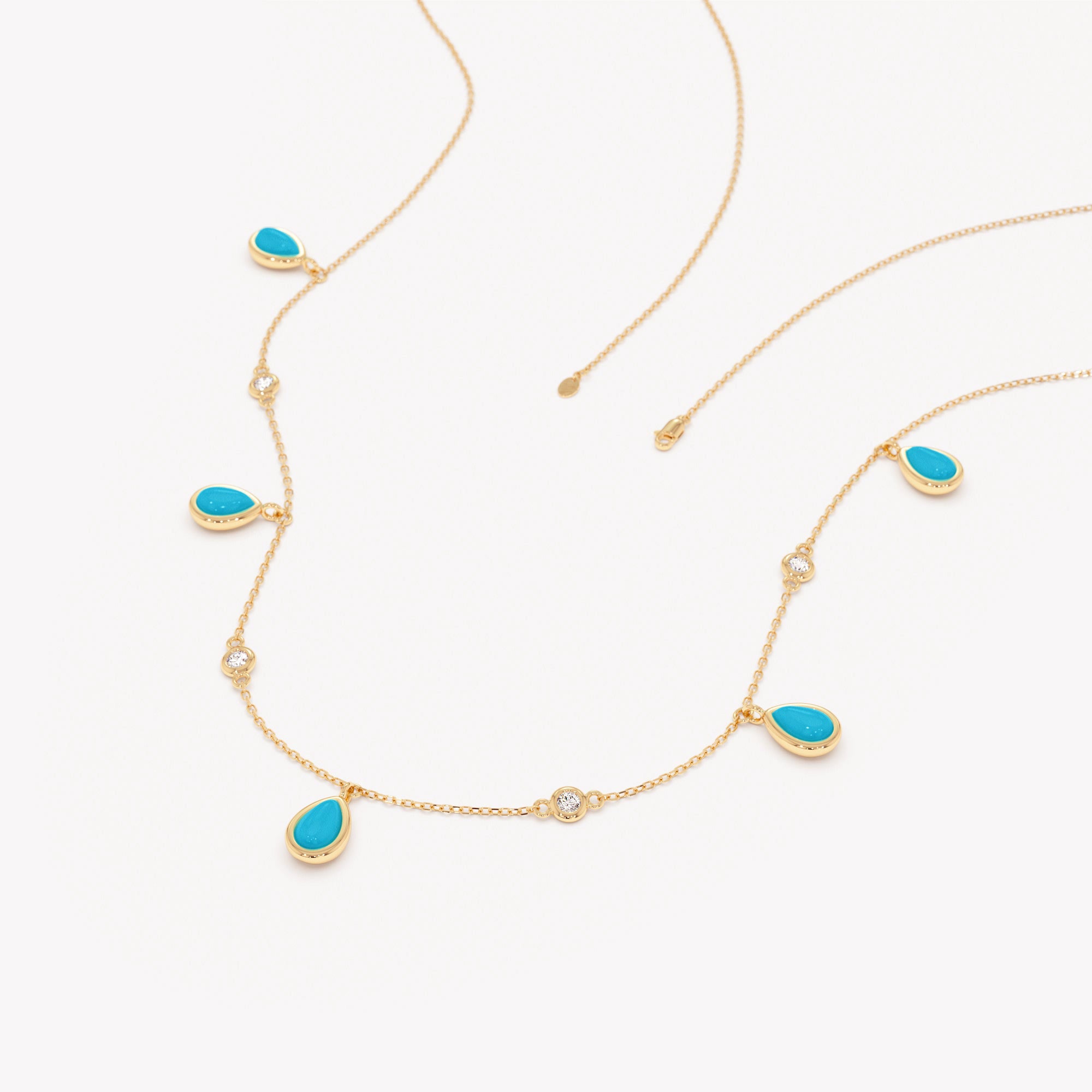 Gold necklace with turquoise stones on a white background